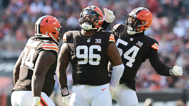 Nov 5, 2023; Cleveland, Ohio, USA; Cleveland Browns defensive tackle Jordan Elliott (96) celebrates a sack with defensive tackle Dalvin Tomlinson (94) and defensive end Ogbo Okoronkwo (54) during the first quarter against the Arizona Cardinals at Cleveland Browns Stadium. Mandatory Credit: Ken Blaze-USA TODAY Sports